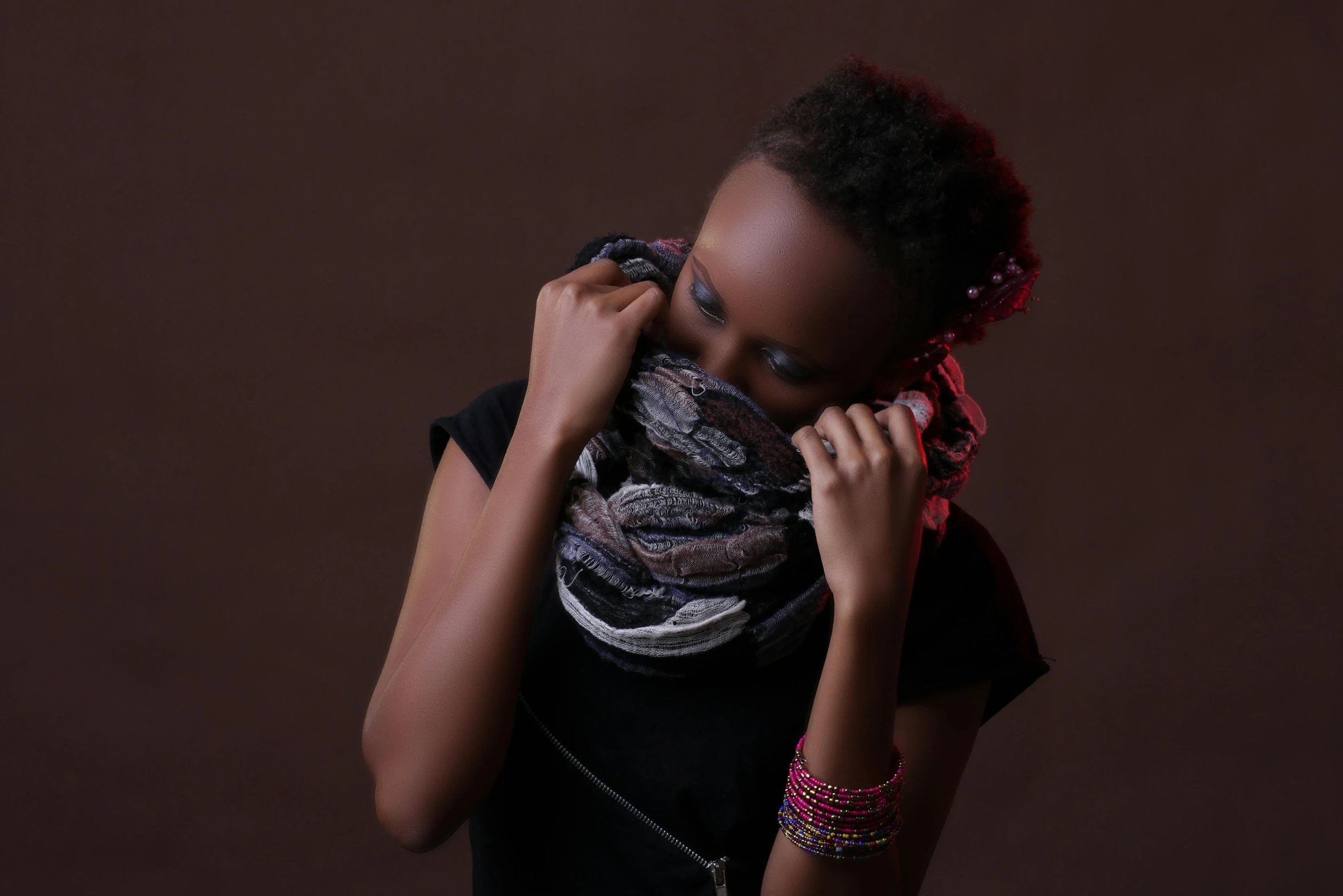 woman in black shirt with scarf on over shoulder