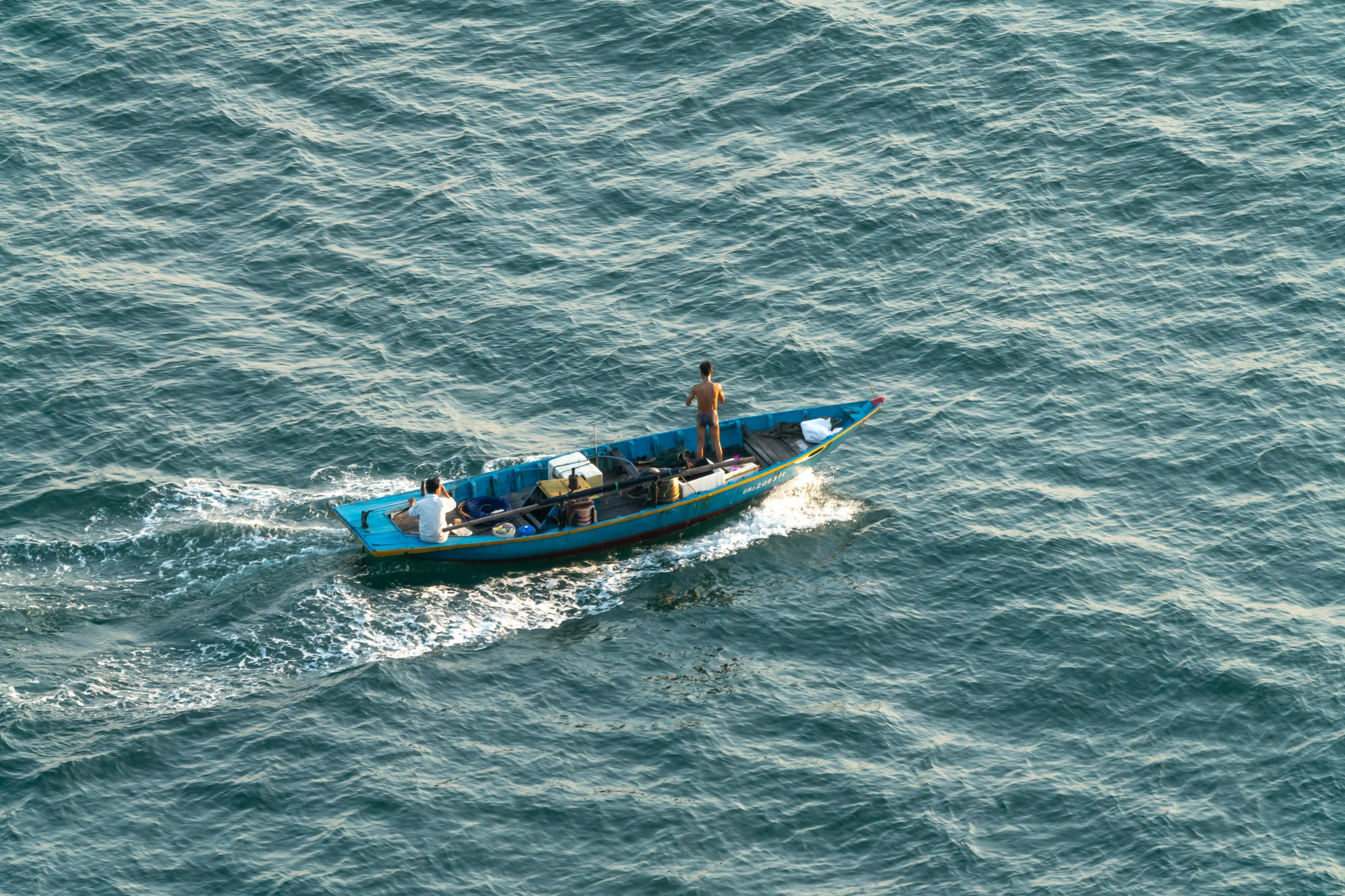 a small boat traveling across the ocean waters