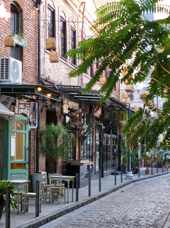 there is a brick building with many small tables