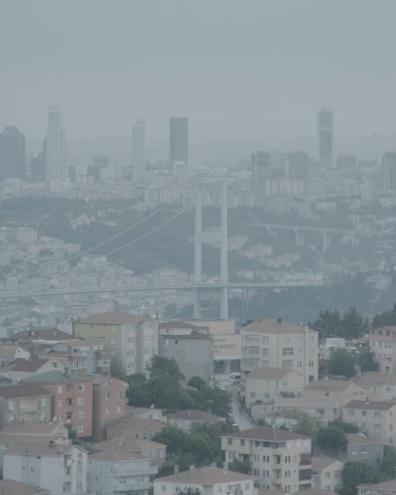 a city skyline, looking at a bridge in the distance