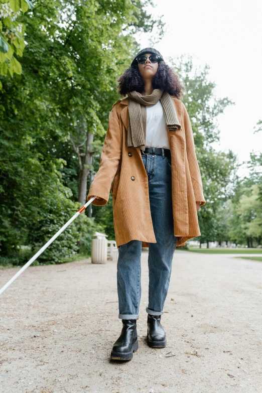 a person in an orange coat and black boots