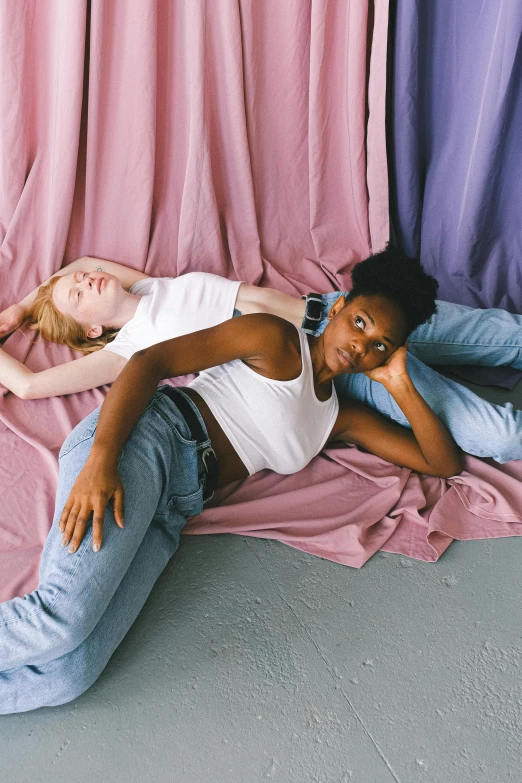 a woman laying on top of two boys on a rug