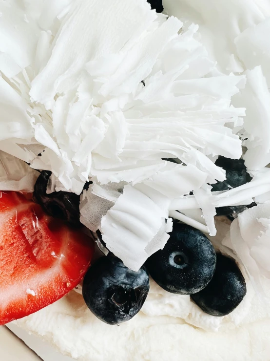 blueberries and strawberries are laid out on a bread