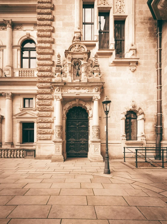 a large building with an open door on the sidewalk