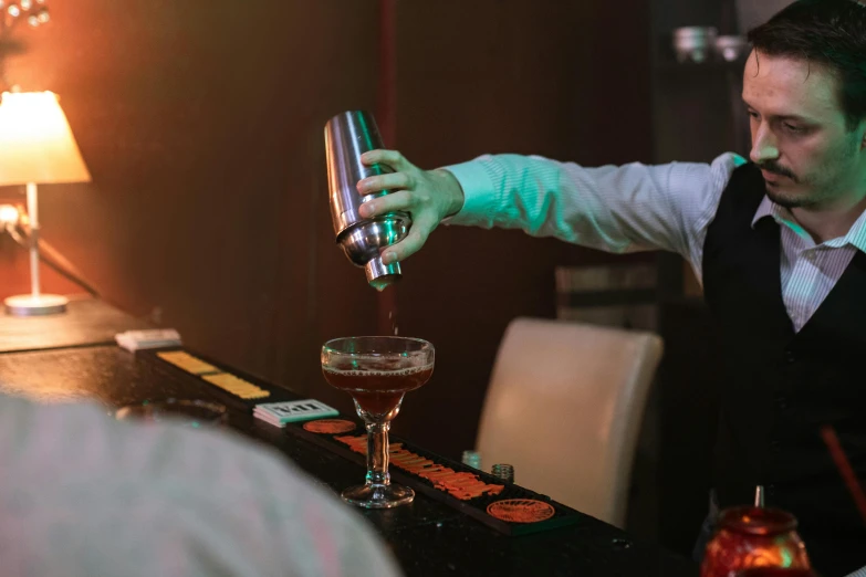 a bartender is preparing a drink on the counter