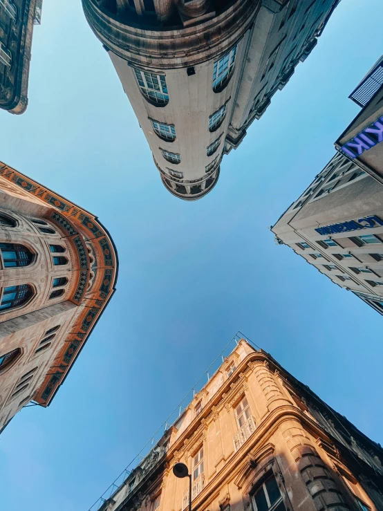 a group of tall buildings sitting under a blue sky