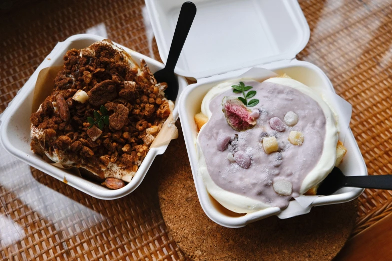 two takeout containers with some kind of food in them