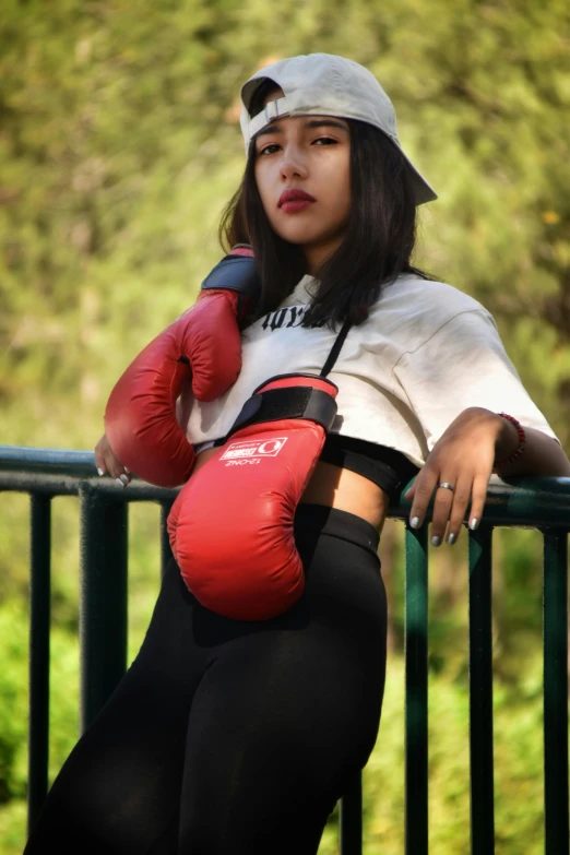 a woman in black pants and red gloves