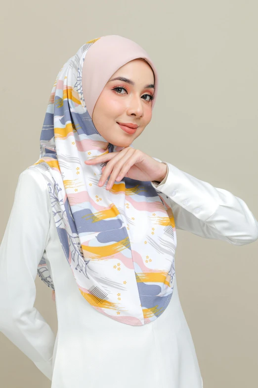 a woman is wearing a white blouse and wearing a pink hijab
