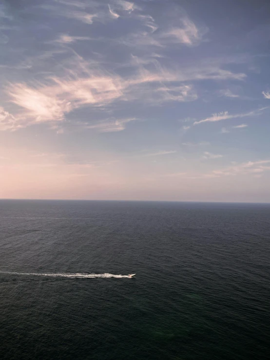 boat sailing on open water and looking toward distant horizon