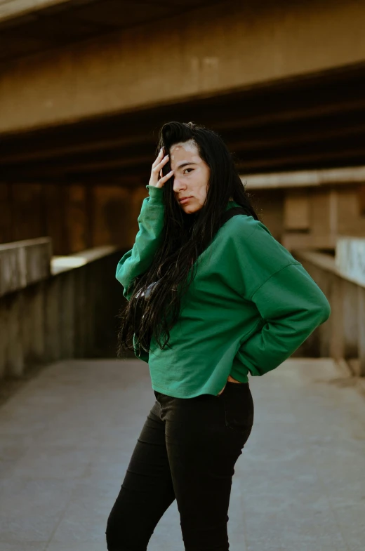 a beautiful woman with long hair wearing black pants