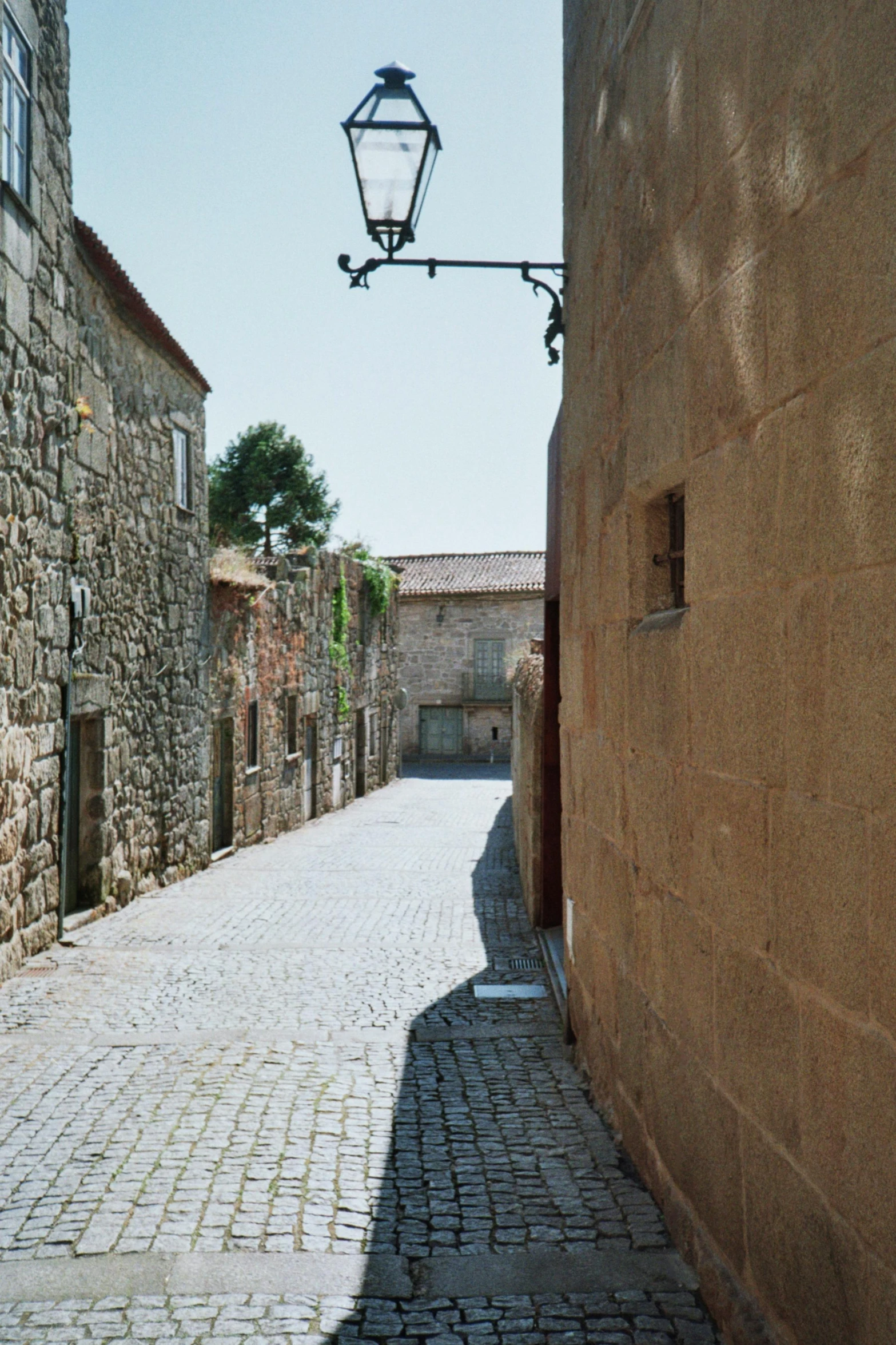 streetlamp over street leading into small cobblestone village