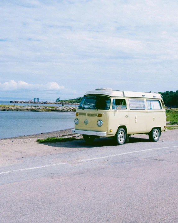 a vw camper is parked on the side of the road