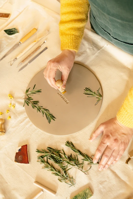 a woman putting a piece of plants on top of a plate