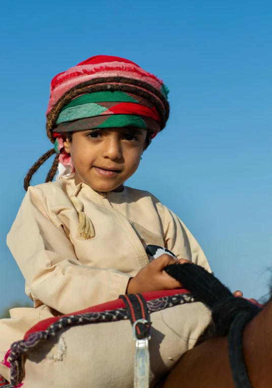 a young child is sitting on top of a horse