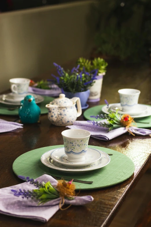 a table that has tea cups and a saucer on it