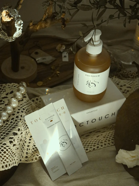 two pieces of fabric and some bottles of perfume on a table