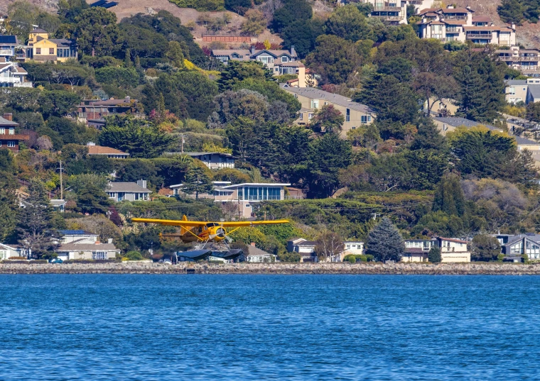 an air plane landing in the middle of a lake