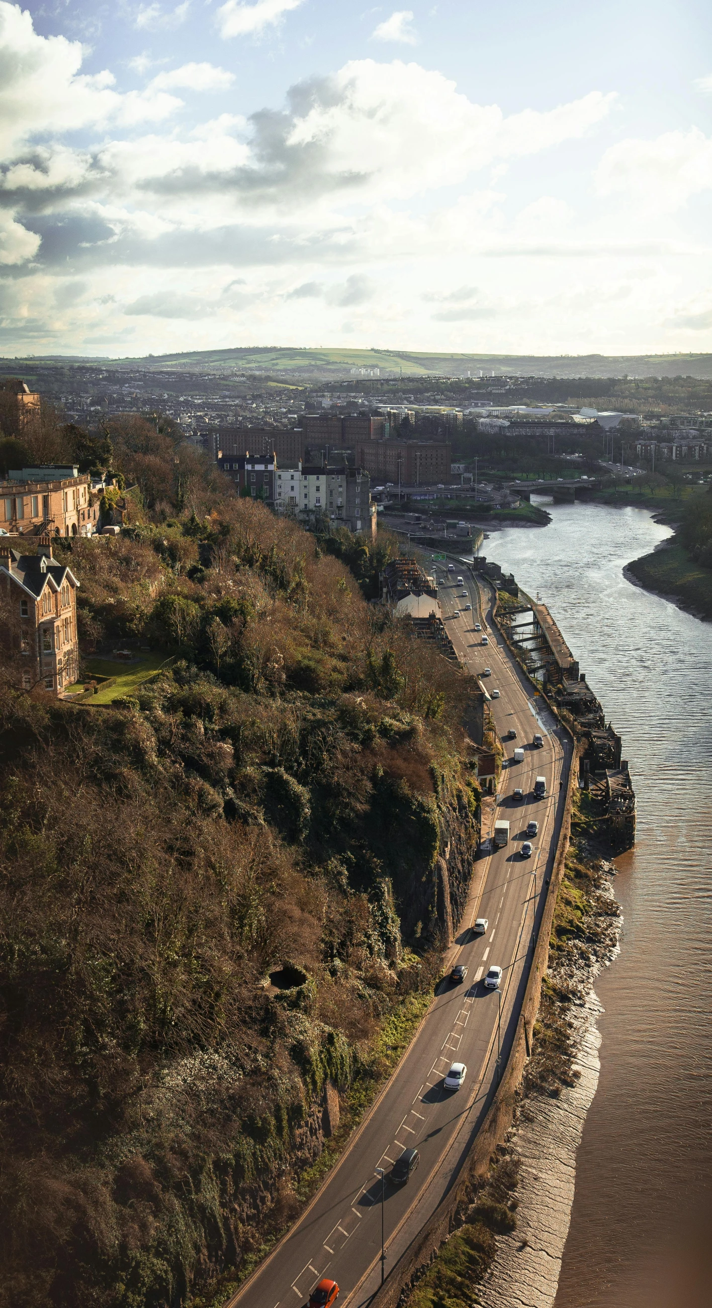 view of an empty freeway overlooking a river and town