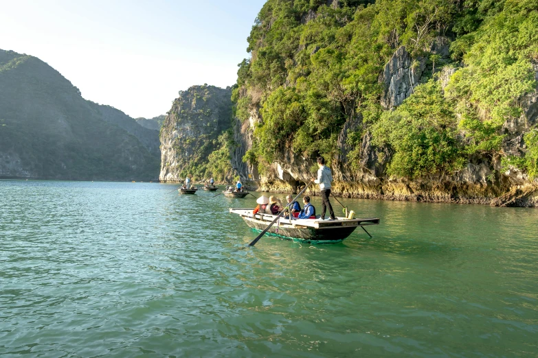 a small boat is in the water near some hills