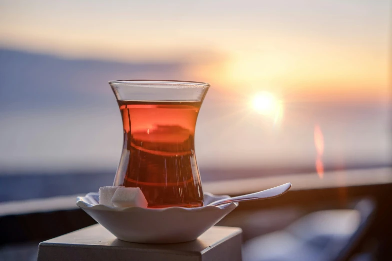 a cup and saucer are on a table with water