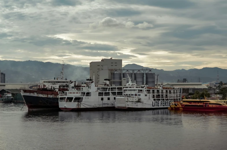 two ferries are docked and one is on the water