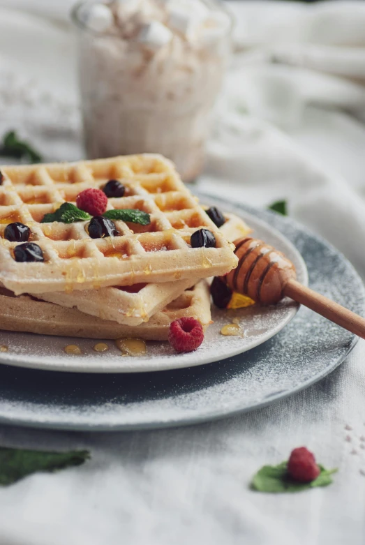 a close up of waffles on a plate with syrup