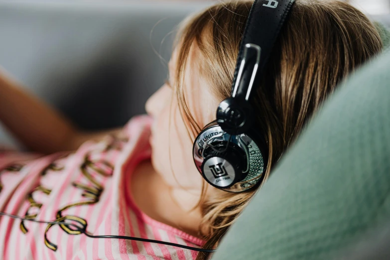 a girl has ear buds on her headphones