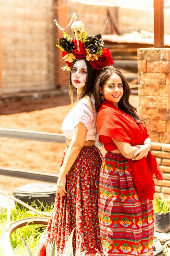two women standing next to each other, with colorful masks and hair