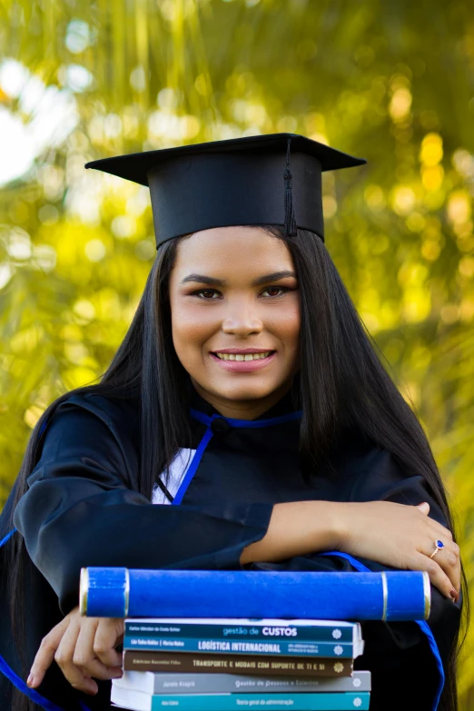 a student wears her cap and gown to graduate