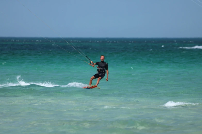 the guy on the water is riding on a board