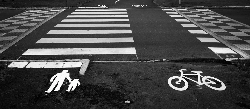 two white painted people walking across the street