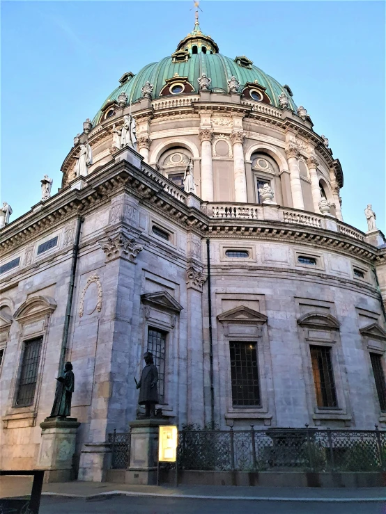 an ornate, historical building with several small statues