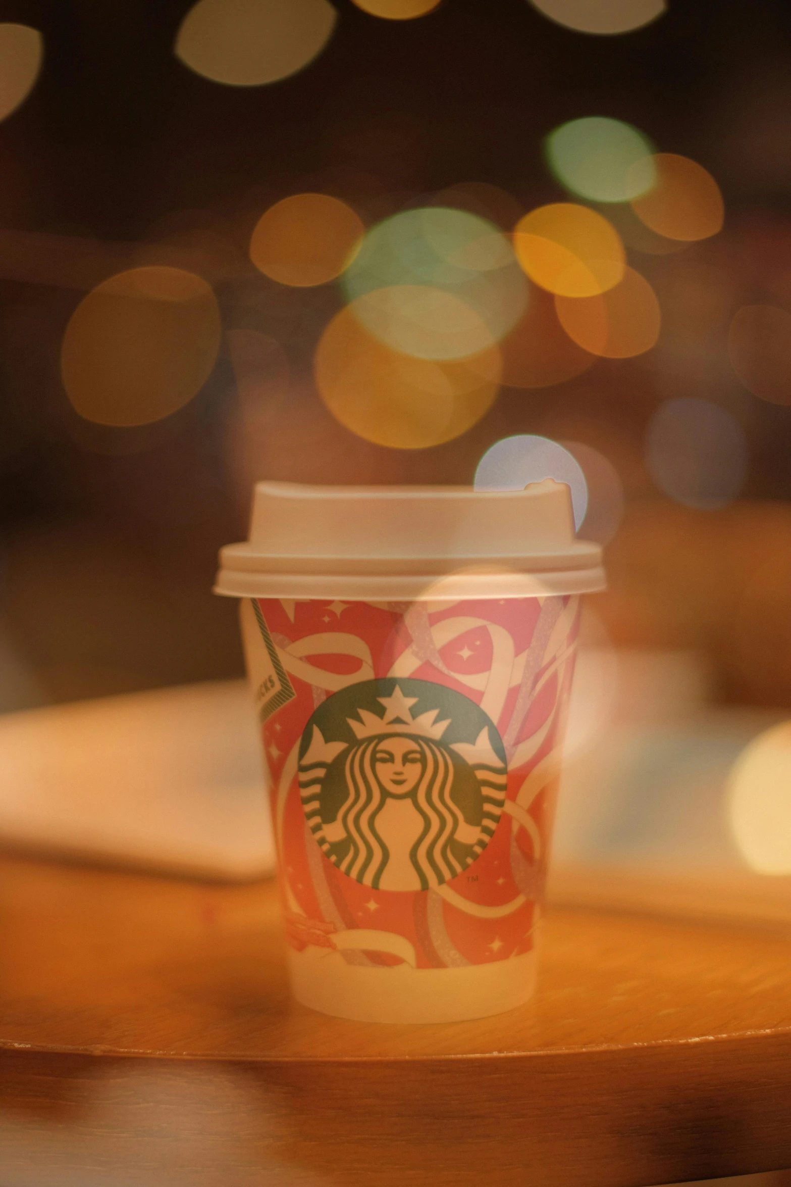 a starbucks cup sitting on top of a table