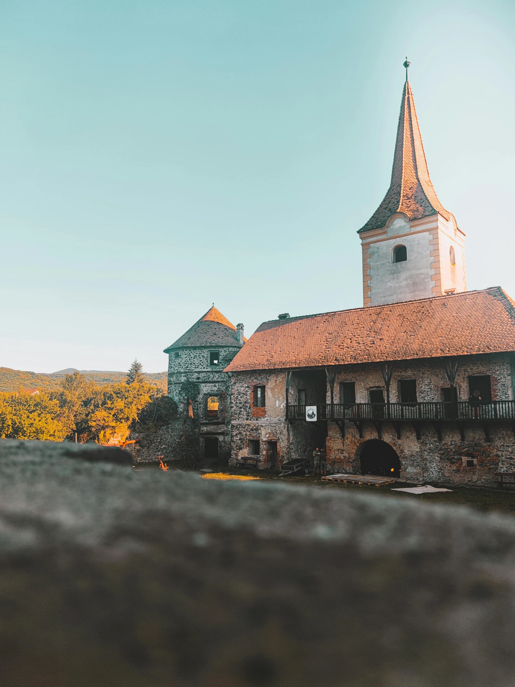 an old building with two towers in the background