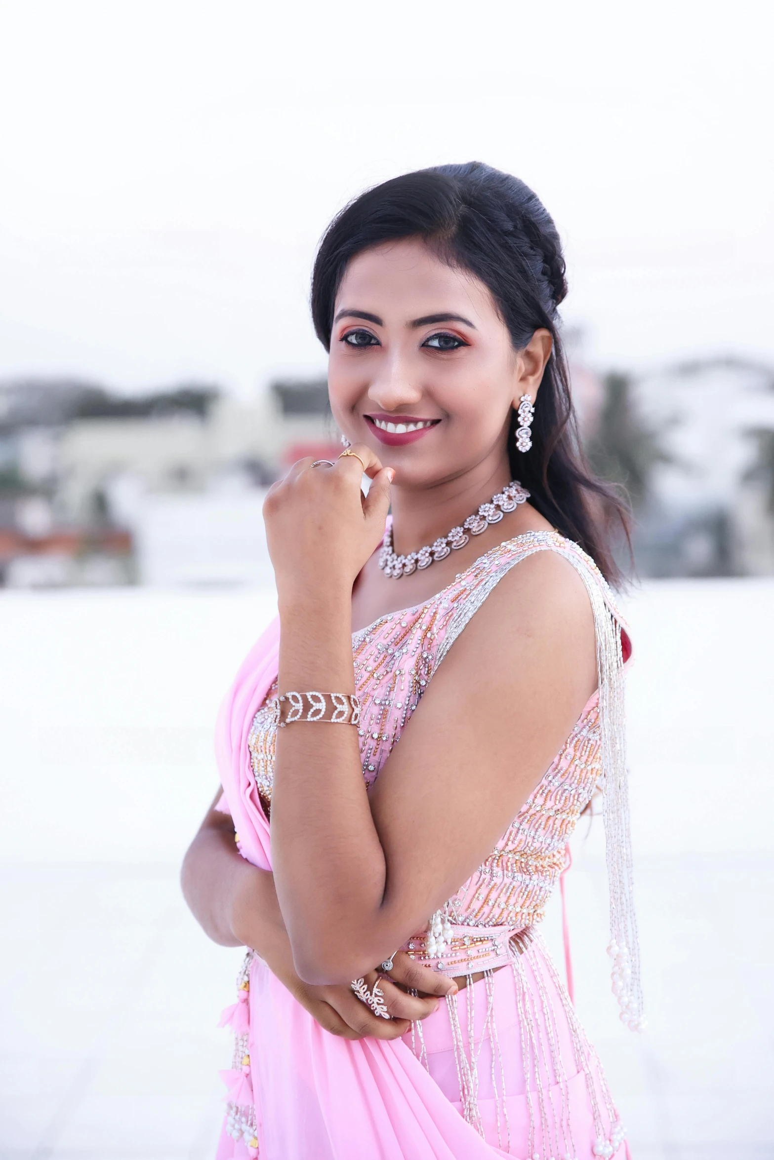 an indian woman in pink posing for the camera