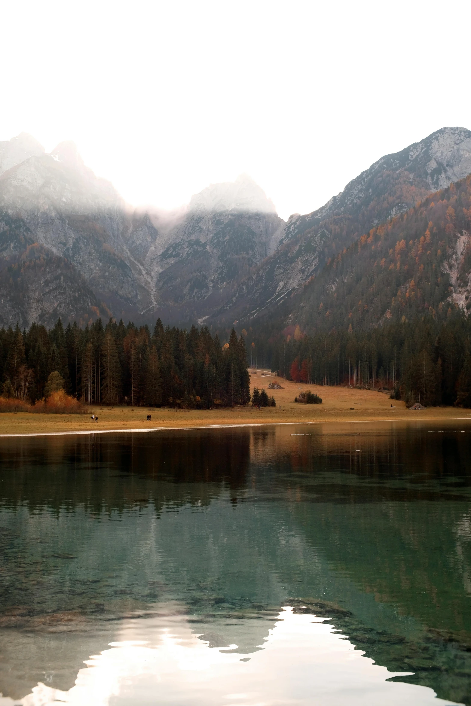 mountains are in the distance and a body of water is in front of them