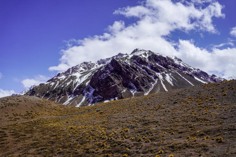 the mountains are covered in very few snow