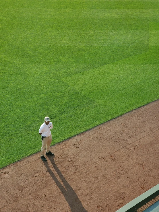 a lone baseball player stands on the field