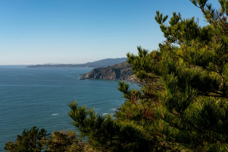 view from top of hill, with sea and mountains in background