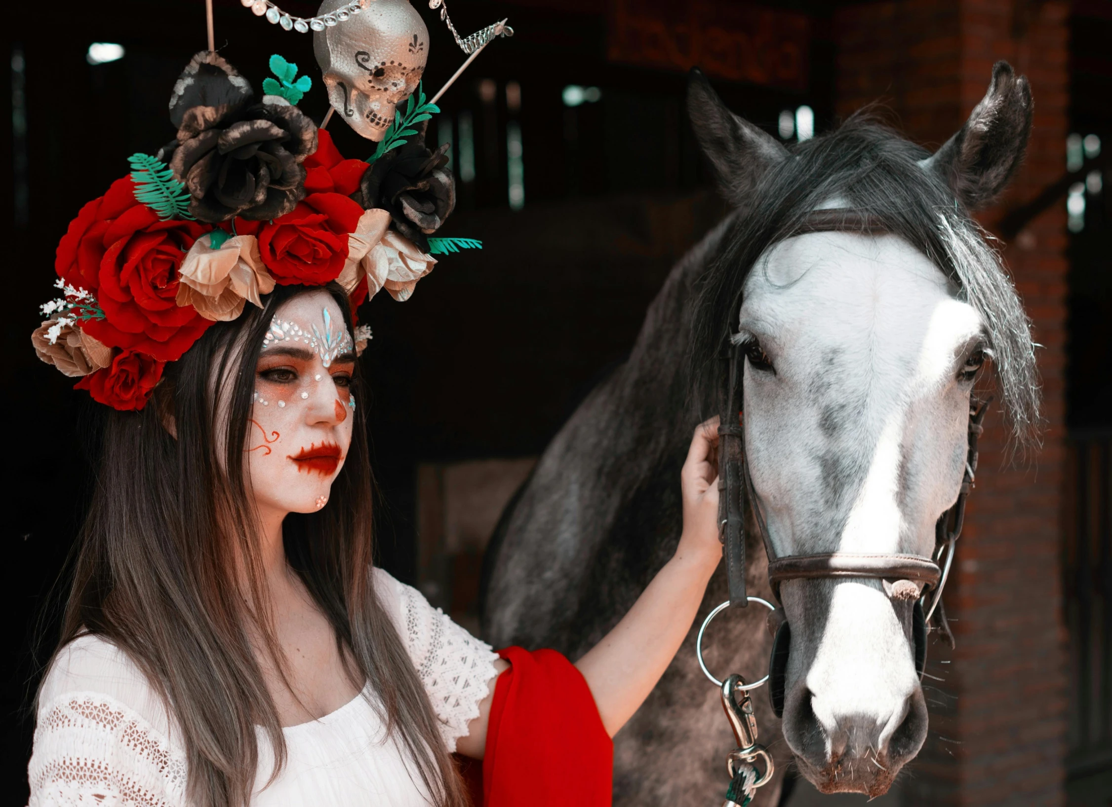 a woman is holding the nose of a horse that is decorated with flowers