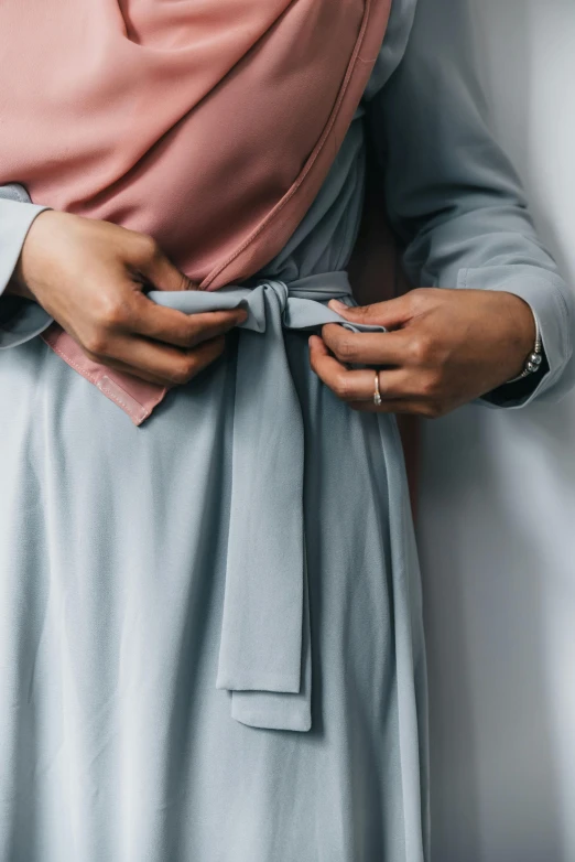 a woman wearing a scarf around her waist