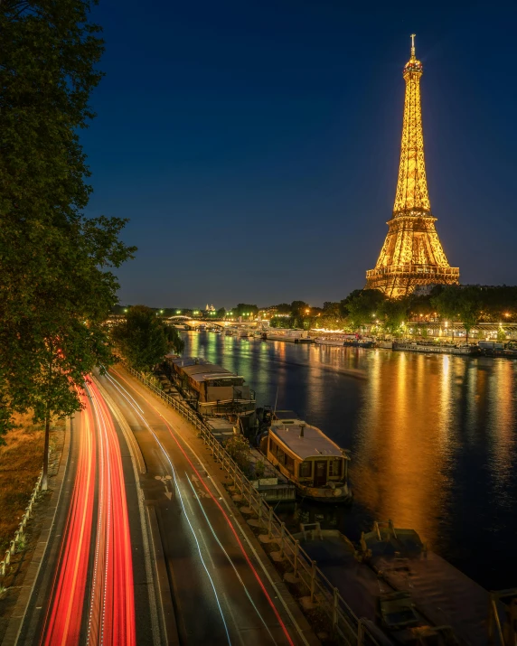 the eiffel tower stands brightly against the dark night sky