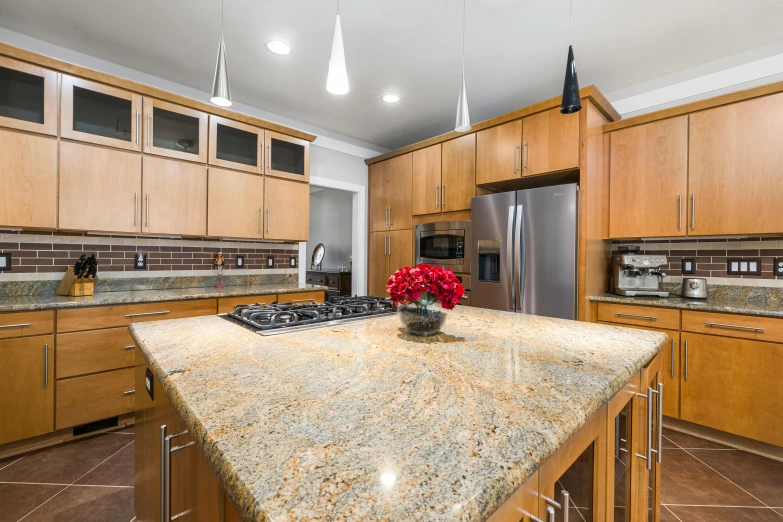 a kitchen with a large center island and stove