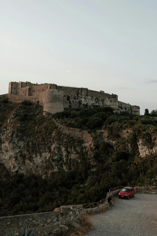 a car is parked in front of a castle