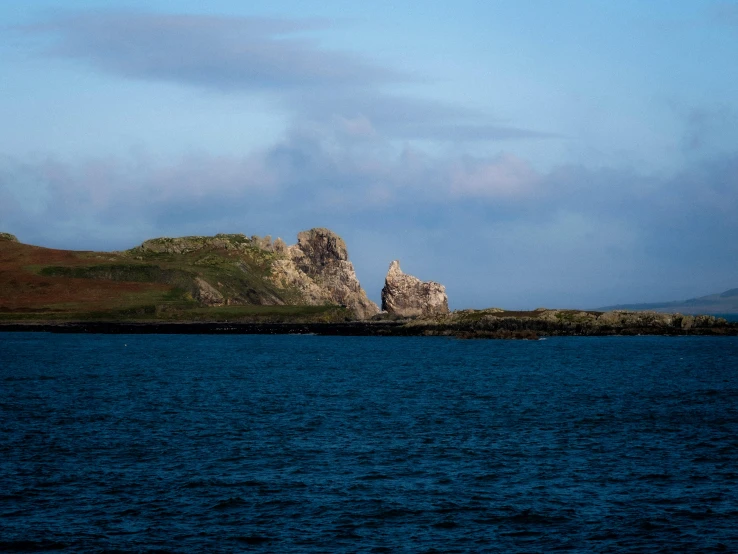 an island sitting off in the middle of a large body of water