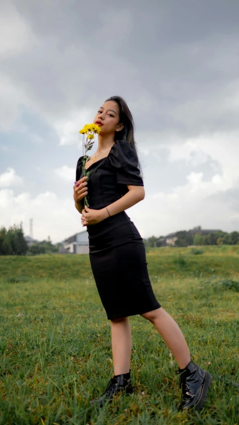 a woman with a flower in a field