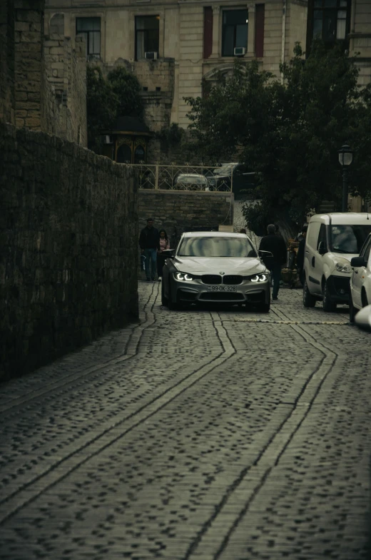 a road with two cars parked in front of the building