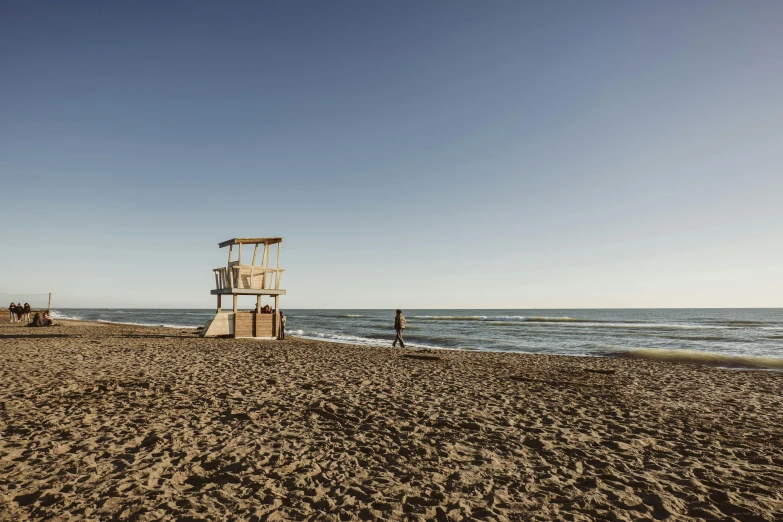 a lifeguard tower on the beach near water