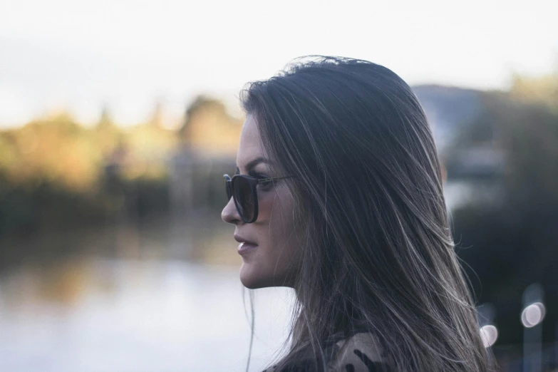 a woman with long hair listening to music in ear buds